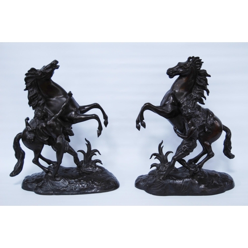 186 - In the Manner of Guillaume Coustou (French)Pair of bronze Marley horse and figure groups, modelled a... 