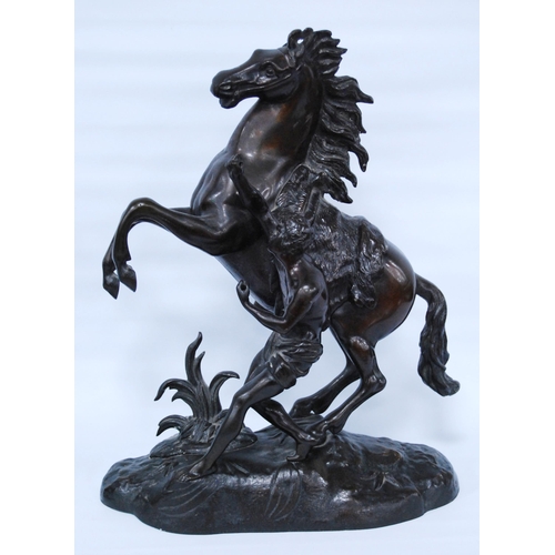 186 - In the Manner of Guillaume Coustou (French)Pair of bronze Marley horse and figure groups, modelled a... 