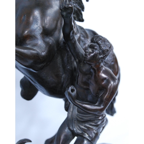 186 - In the Manner of Guillaume Coustou (French)Pair of bronze Marley horse and figure groups, modelled a... 