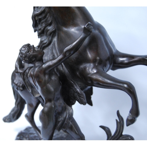 186 - In the Manner of Guillaume Coustou (French)Pair of bronze Marley horse and figure groups, modelled a... 