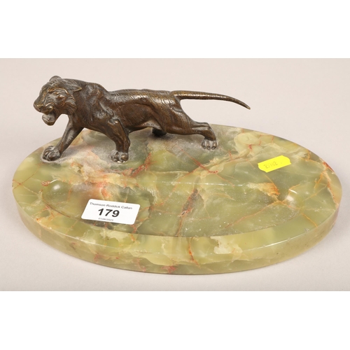 179 - Aspreys bronze model of a tiger desk stand on oval green marble base 24cm