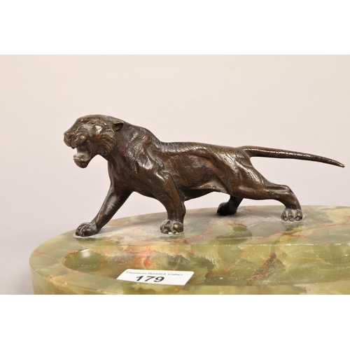 179 - Aspreys bronze model of a tiger desk stand on oval green marble base 24cm