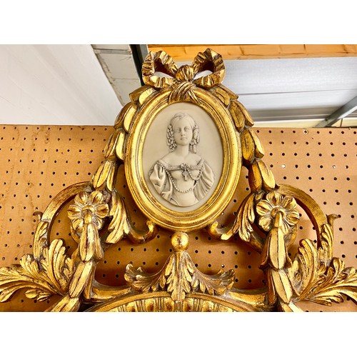 384 - Gilt oval mirror with oval cartouche of an early Victorian lady with bevel edge 109 x 59 cm 