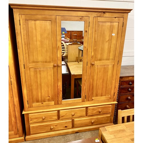 579 - Three door pine wardrobe with mirror over five drawers 150 x 201 x 59 cm