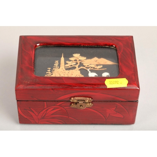 108 - Japanese cork scene jewellery box containing assortment of costume jewellery and pearl necklaces