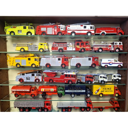 420 - Collection of die cast vehicles including fire engines in glass fronted wall cabinet