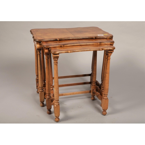 473 - Nest of three walnut topped tables with scalloped edges