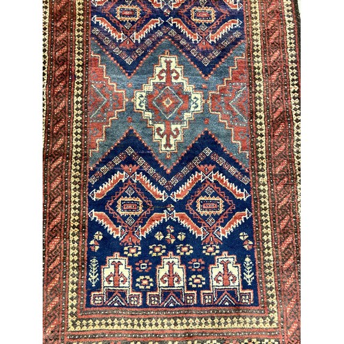 527 - Middle eastern wool rug on red brown ground 77 x 57cm