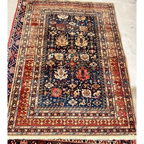 604 - Middle eastern style 'Samarkand' woollen rug, blue and red on brown ground 188 x 134 cm