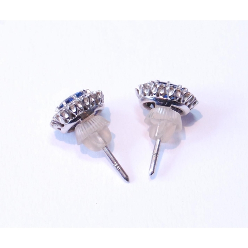 124 - Pair of sapphire and diamond cluster earrings, unmarked, probably white gold, with central oval-cut ... 