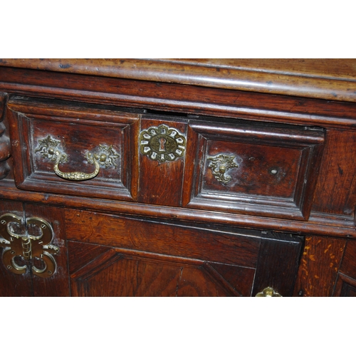 412 - 19th century oak dresser, the breakfront top section with four panelled doors enclosing a shelved in... 