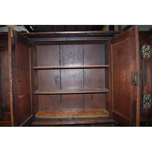 412 - 19th century oak dresser, the breakfront top section with four panelled doors enclosing a shelved in... 