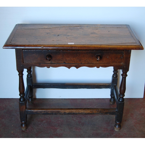 414 - English Arts & Crafts Oak writing table, the long drawer with ornate peg handles, on turned supp... 