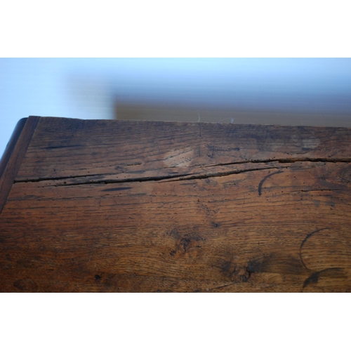 414 - English Arts & Crafts Oak writing table, the long drawer with ornate peg handles, on turned supp... 