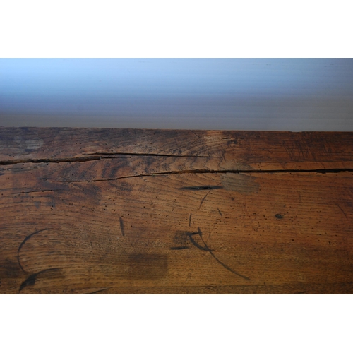 414 - English Arts & Crafts Oak writing table, the long drawer with ornate peg handles, on turned supp... 