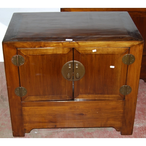 407 - Pair of Chinese elm cupboards (last quarter 20th century) of low form with two doors enclosing a she... 