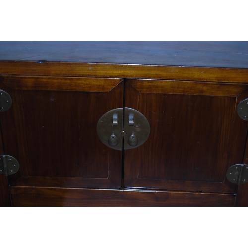 407 - Pair of Chinese elm cupboards (last quarter 20th century) of low form with two doors enclosing a she... 