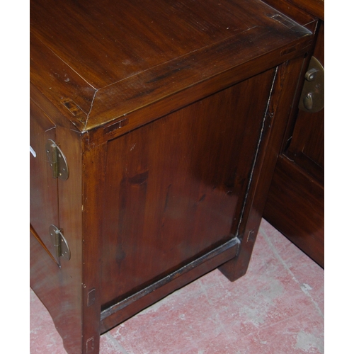 407 - Pair of Chinese elm cupboards (last quarter 20th century) of low form with two doors enclosing a she... 