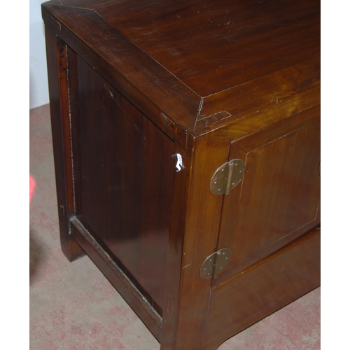 407 - Pair of Chinese elm cupboards (last quarter 20th century) of low form with two doors enclosing a she... 