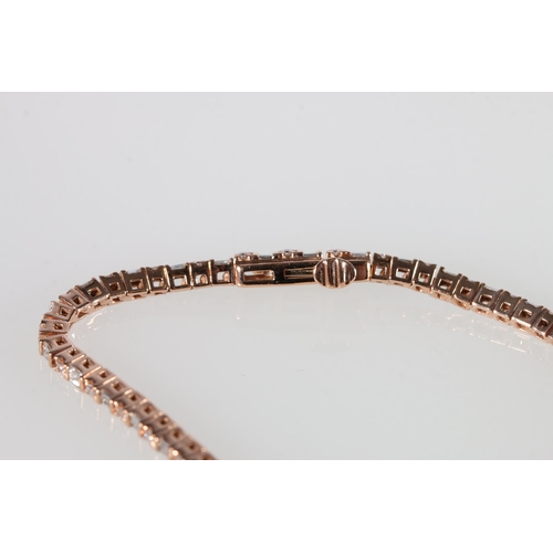 72 - 10ct rose gold bracelet set with baguette and round brilliant-cut diamonds, with open box clasp and ... 