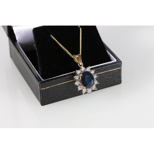 84 - 9ct yellow gold oval sapphire and diamond cluster pendant on a gold-coated silver chain, sapphire we... 