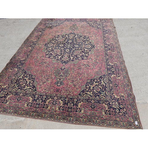 694 - Pink and black ground rug.