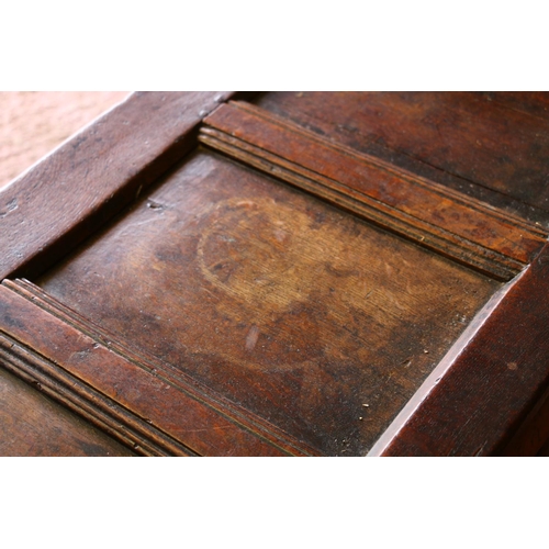 840 - 17th century oak coffer, the panelled top on later hinges, interior with candle box lacking lid, fro... 