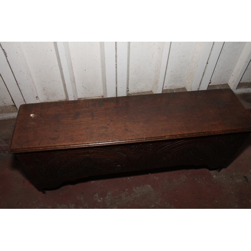 844 - Oak coffer with the hinged lid over interior with candle box, front having carved decoration, raised... 