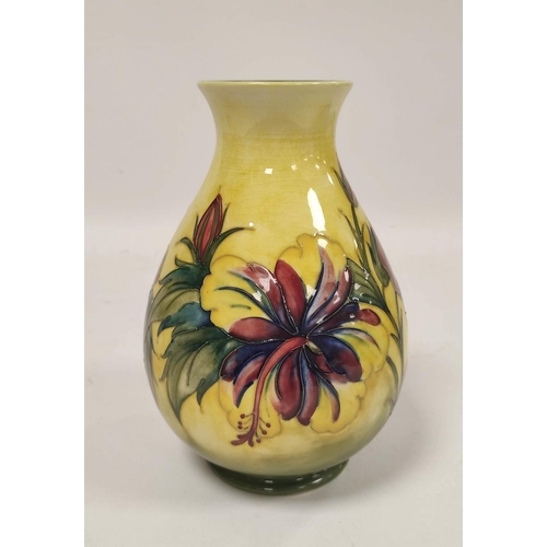 257 - William Moorcroft Hibiscus design pottery vase, the oviform vase tube lined on yellow ground, green ... 