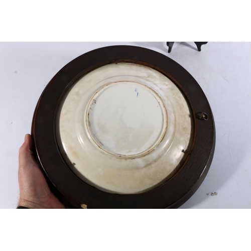 24 - Antique English porcelain dish decorated in the Imari palate, 26cm diameter, held within an oak wall... 