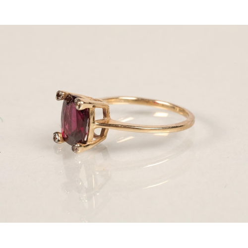 55 - Ladies 9ct gold dress ring with four orange stones surrounding large purple stonering size O
