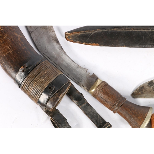 104 - Two Kukri with miniature fork and knife also a eastern dagger in carved wooden sheath  (3)