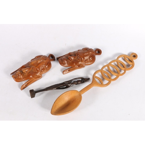 171 - Two small treen African masks, an African figure, and a carved treen spoon.