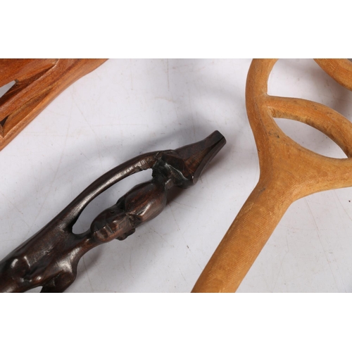 171 - Two small treen African masks, an African figure, and a carved treen spoon.