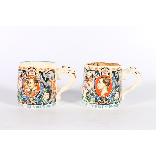 63 - Two coronation mugs designed and modelled by Dame Laura Knight, one with papers (2).