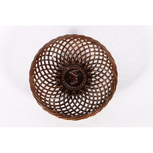 64 - Treacle style glazed pottery dish in the form of a woven basket decorated with central bust of a gen... 