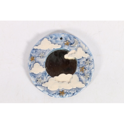 67 - Circular studio pottery mirror titled 'Head in the clouds' by CM? Measures 12cm diameter.