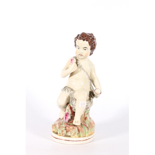 92 - Staffordshire style model of a boy seated on tree stump,  23cm.