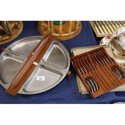 141 - Stainless steel and wooden segmented lazy susan and a set of wooden handle knives and forks.