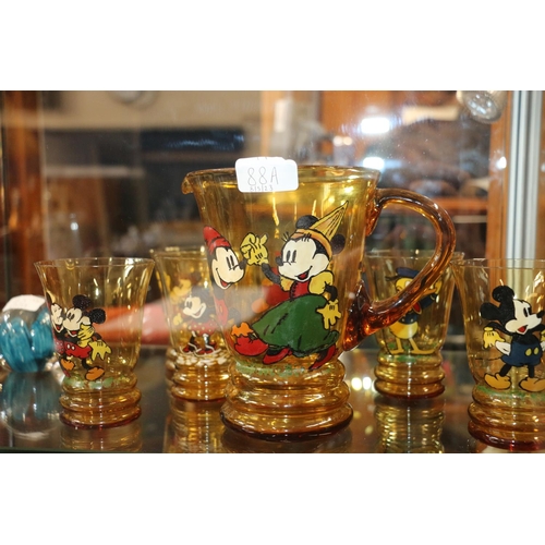 88A - Art deco amber glass lemonade set decorated with hand painted Mickey Mouse characters, jug and six g... 