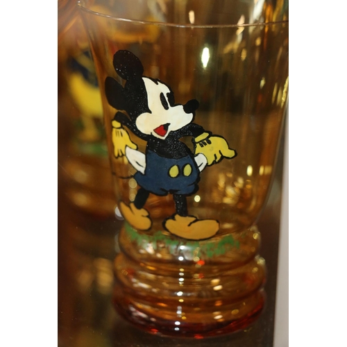 88A - Art deco amber glass lemonade set decorated with hand painted Mickey Mouse characters, jug and six g... 