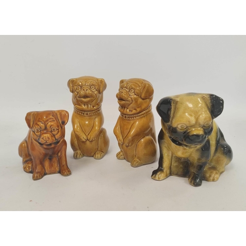 267 - Four early 20th century assorted ceramic pug, and similar, dog models, all in seated poses, to inclu... 