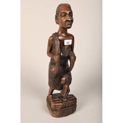 231 - Tribal figure of a mother and child 50cm another of a figure holding a spear, wall mask and carved f... 