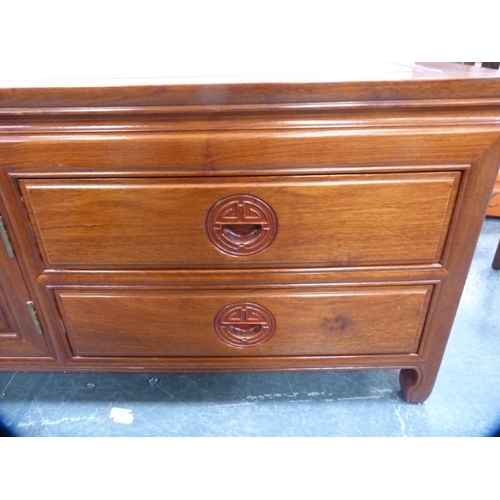 518 - Chinese-style cherry wood low cabinet fitted with central cupboards flanked by drawers.