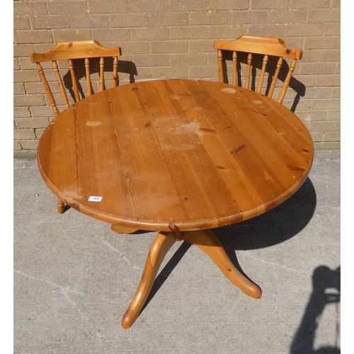 314 - Circular pine dining table and two chairs.