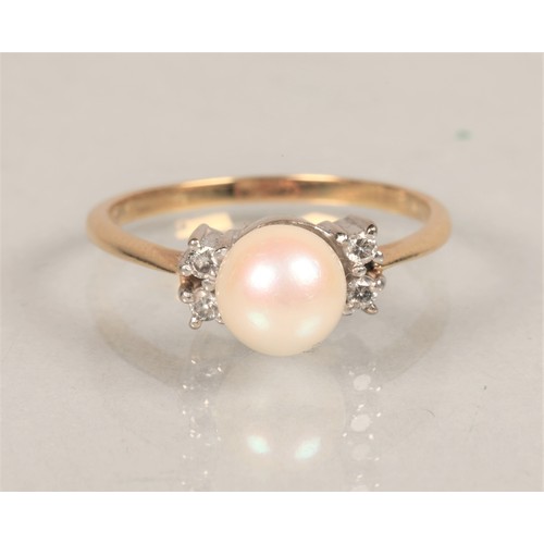 63 - Ladies 18ct gold ring set with a pearl and two small Diamonds at either side ring size N