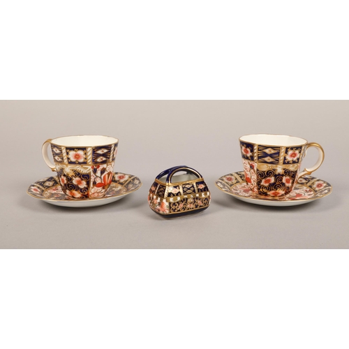 13 - Pair of crown derby cup and saucers with an ornamental bag