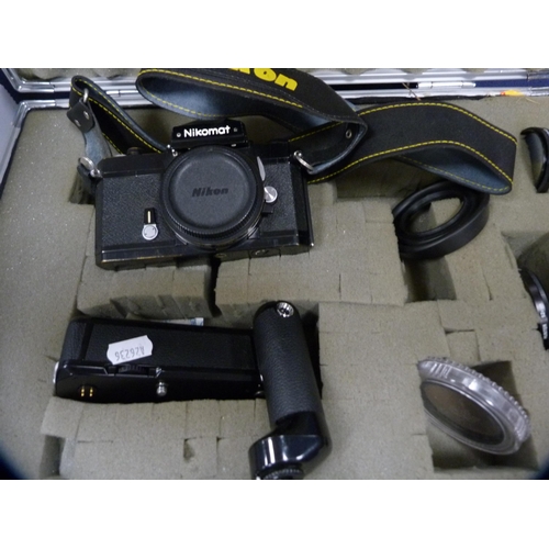 69 - Nikon Nikomat camera with flash and accessories, in fitted case.
