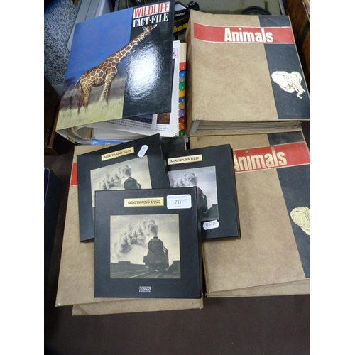 70 - Three boxes of Atlas model trains, boxed, and a collection of wildlife index fact files etc.