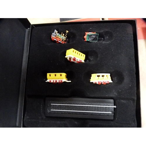 70 - Three boxes of Atlas model trains, boxed, and a collection of wildlife index fact files etc.